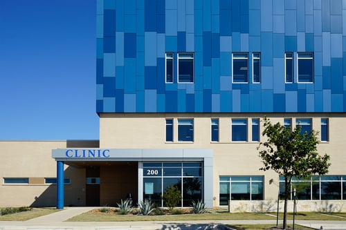 outside of a hospital with different shades of metallic blue panels