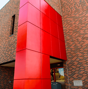 Building exterior with brick and red exterior panels
