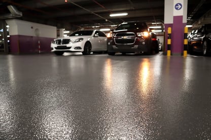 repaired parking garage surface with cars
