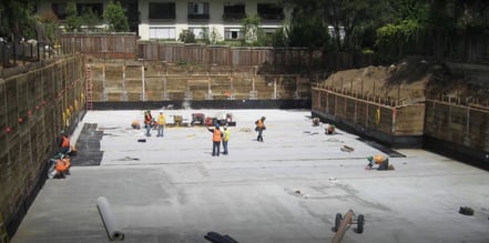 Various workers are on a job site, and they are applying waterproof caulking to the project.