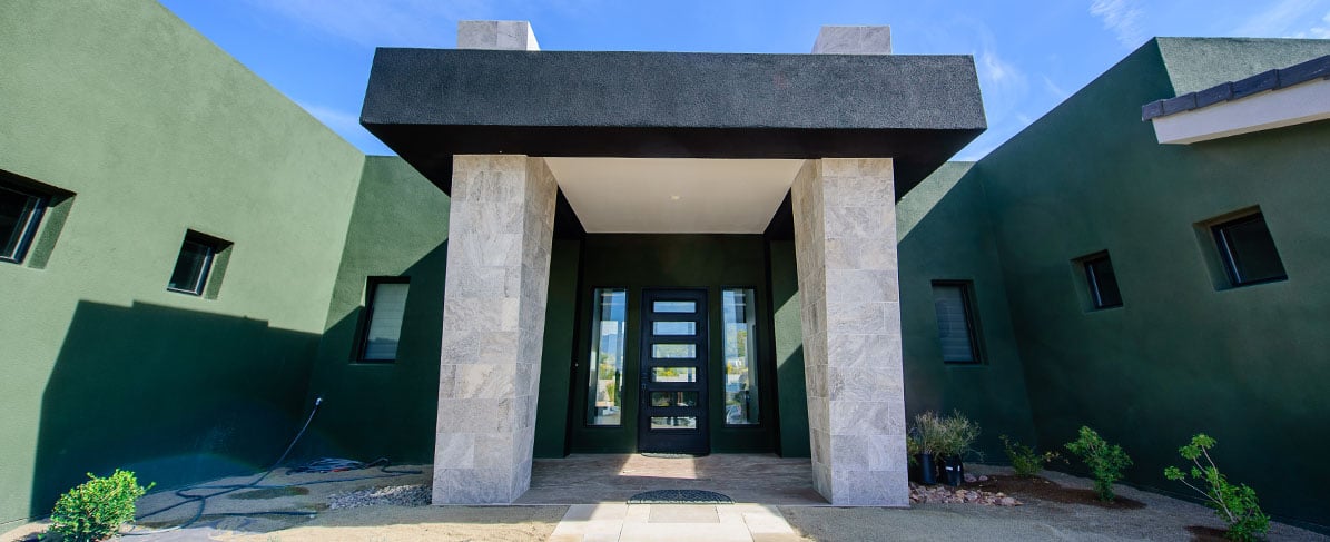 gray stone entryway of a home with a green exterior finish
