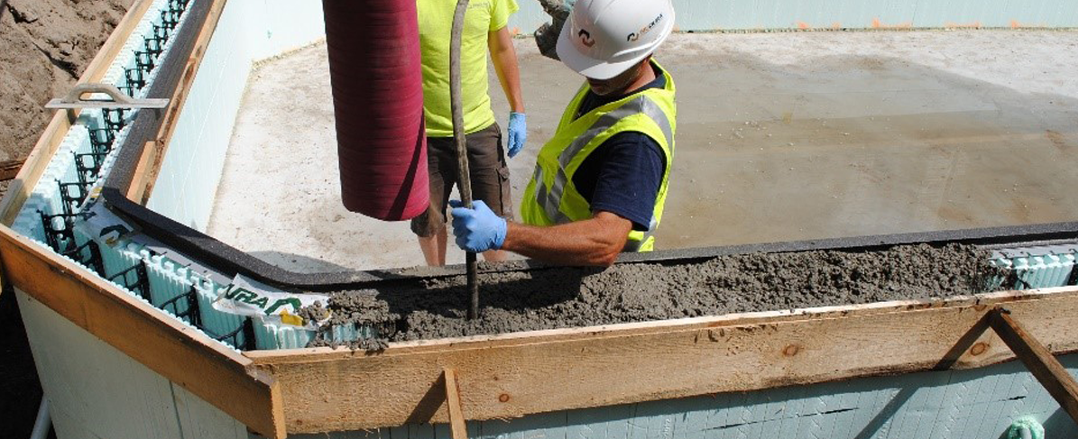 construction worker spraying concrete into ICF wall